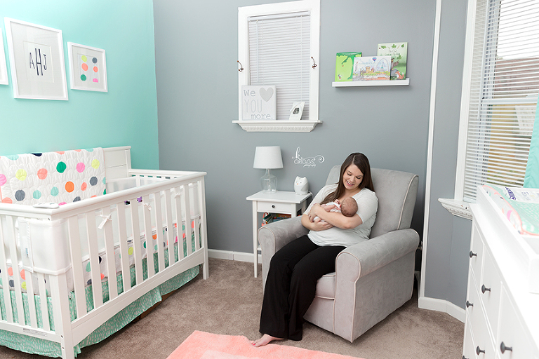 Mom rocking newborn baby in her nursery. | St. Louis Photographer