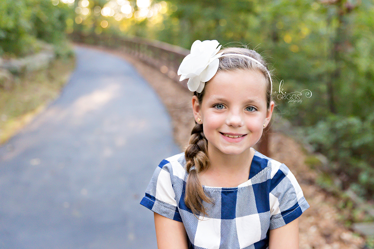 Girl in pretty dress looking at camera Longview Farm Park | St. Louis Photographer