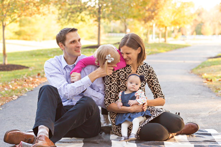 Family sitting in park playing | St. Louis Photographer