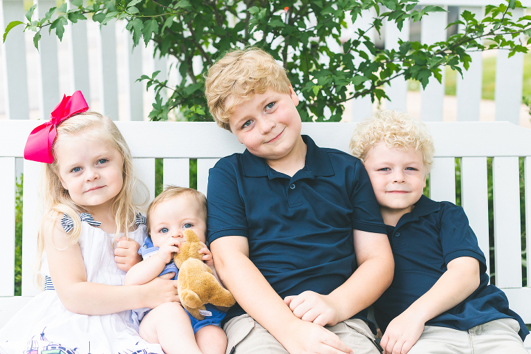 Siblings sitting on bench smiling at camera | St. Louis Children's Photographer