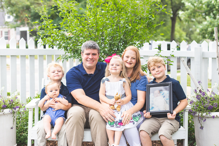 Mom, Dad, and 4 kiddos sitting on white bench smiling | St. Louis Family Photography