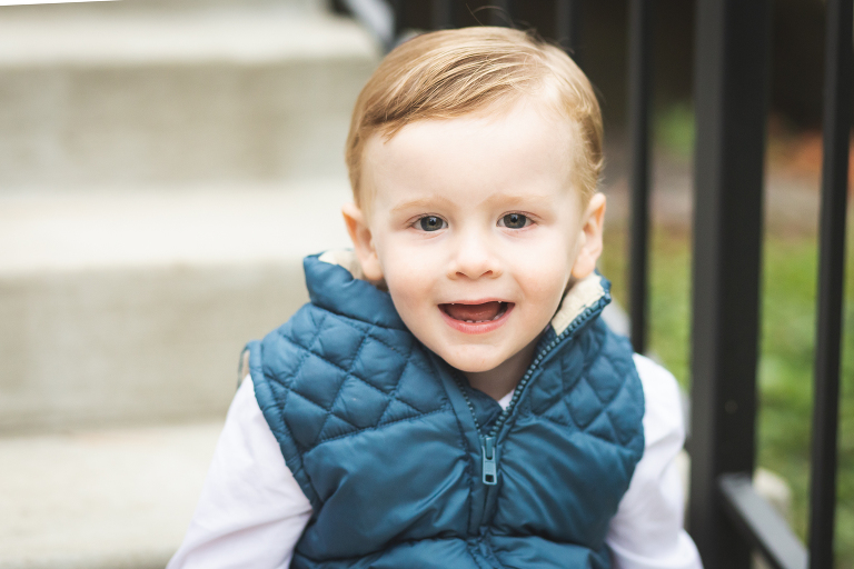 Little boy looking and smiling at camera at Oak Knoll Park | St. Louis Children's Photographer